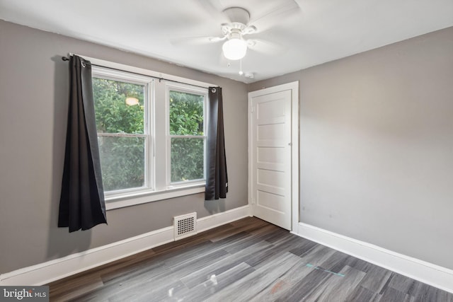 unfurnished room featuring ceiling fan and dark hardwood / wood-style floors