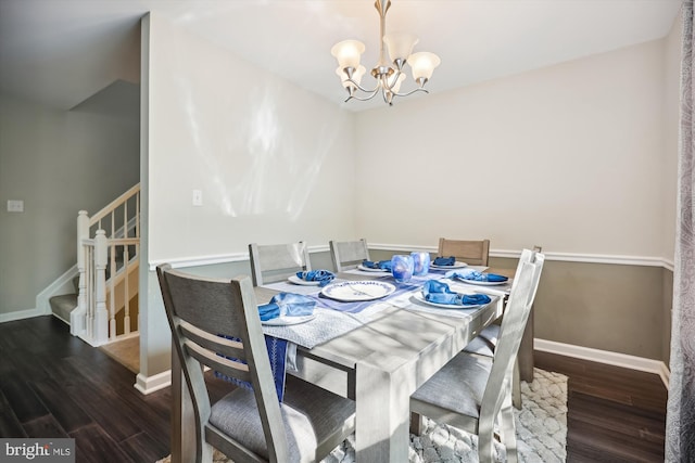 dining space with dark wood-type flooring and a notable chandelier