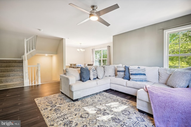 living room with ceiling fan with notable chandelier, dark hardwood / wood-style floors, and a healthy amount of sunlight