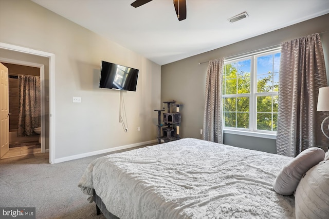 bedroom featuring carpet flooring, ensuite bath, and ceiling fan