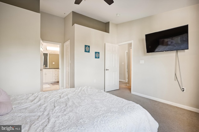 carpeted bedroom with ceiling fan and ensuite bath