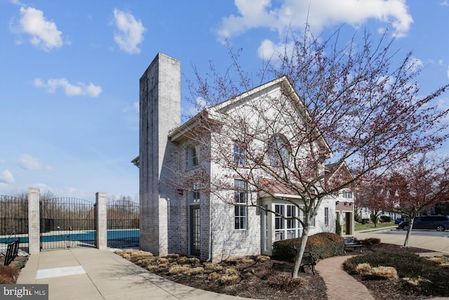 view of side of home with a covered pool