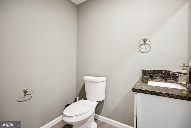 bathroom featuring hardwood / wood-style flooring, vanity, and toilet