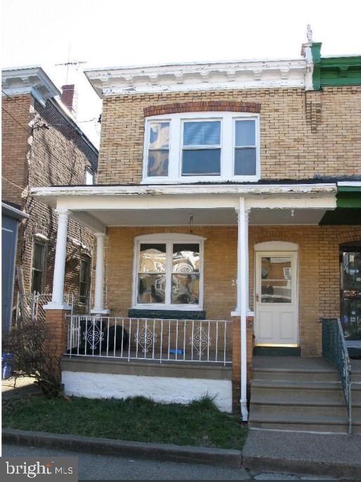 view of exterior entry with a porch