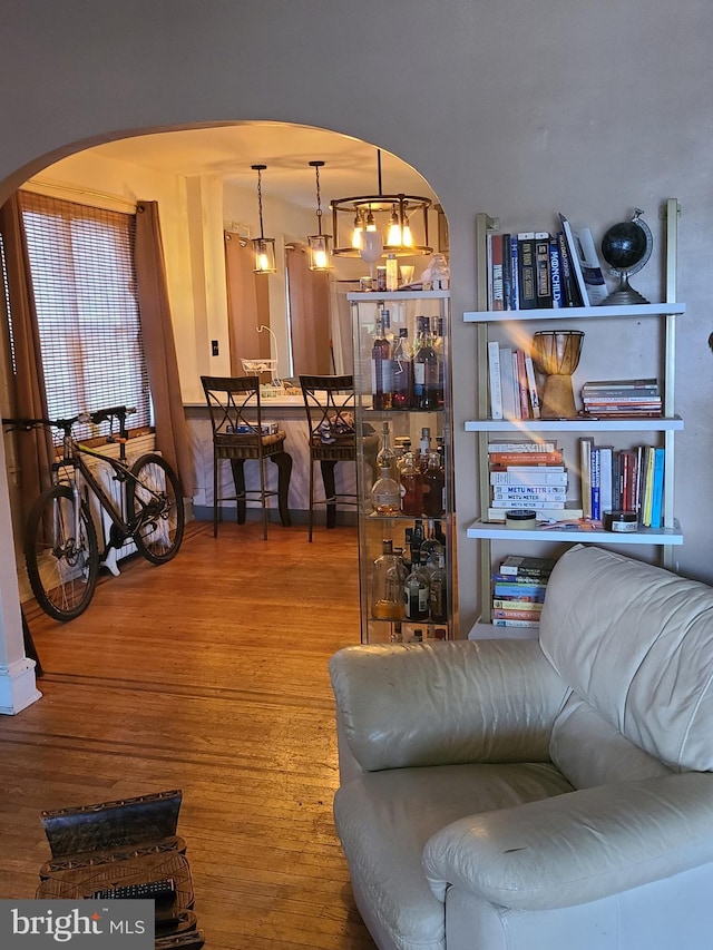 living room with hardwood / wood-style floors and a notable chandelier