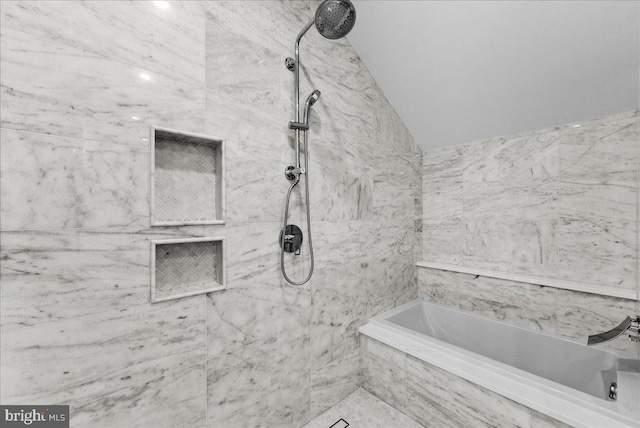 bathroom featuring lofted ceiling and independent shower and bath