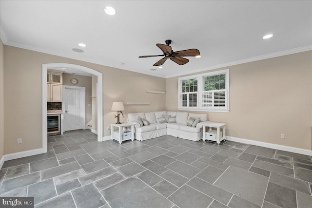 unfurnished living room featuring ceiling fan, crown molding, and beverage cooler