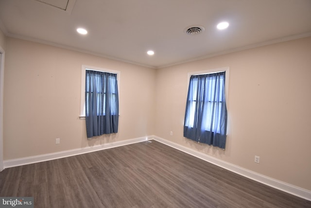 unfurnished room with ornamental molding and dark wood-type flooring