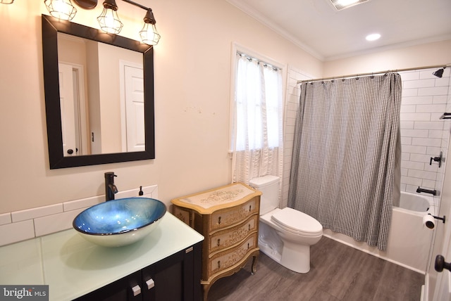 full bathroom with vanity, shower / tub combo with curtain, crown molding, hardwood / wood-style flooring, and toilet