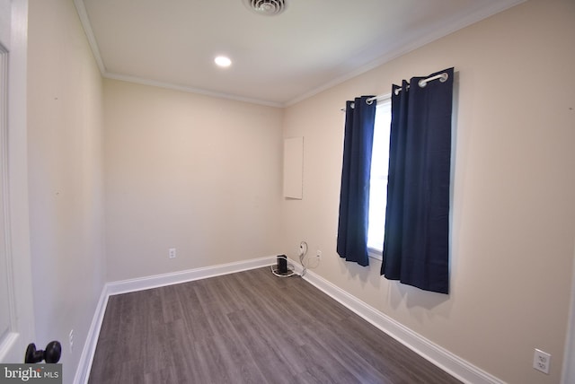 spare room with hardwood / wood-style floors and crown molding