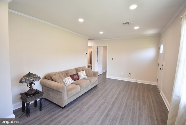 living room with hardwood / wood-style floors and crown molding