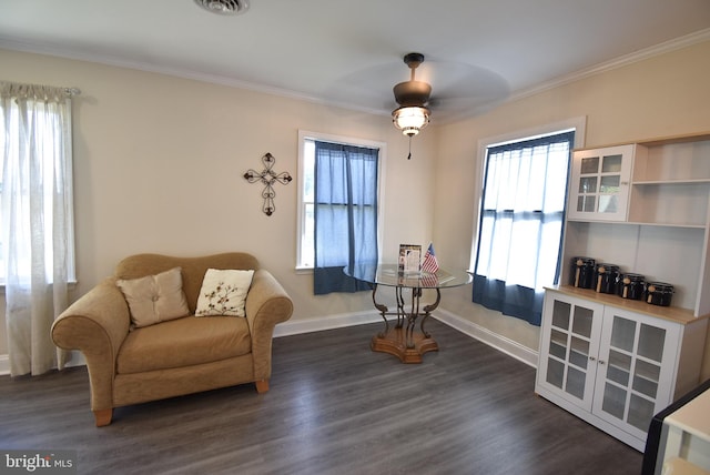 living area featuring ceiling fan, ornamental molding, and dark wood-type flooring