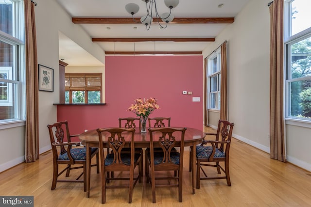 dining space with beamed ceiling, light wood-type flooring, and an inviting chandelier