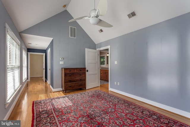 unfurnished bedroom with ceiling fan, light hardwood / wood-style flooring, and high vaulted ceiling