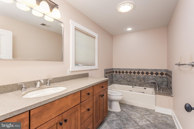 bathroom featuring vanity, toilet, and a tub