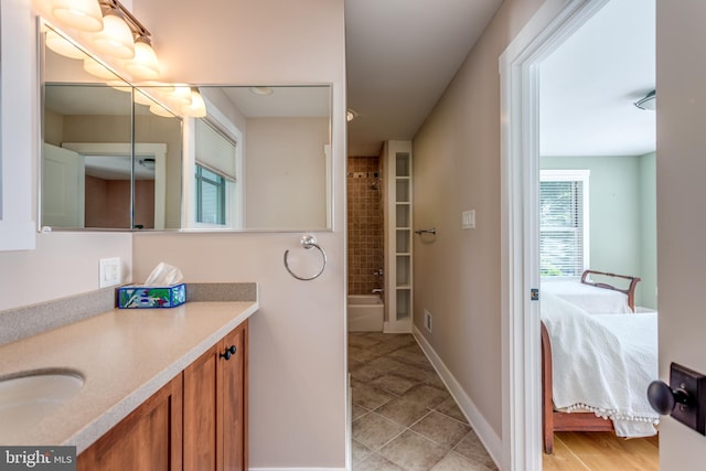 bathroom featuring tile patterned flooring, vanity, and tub / shower combination