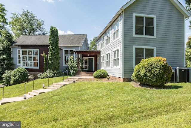 back of house with a lawn