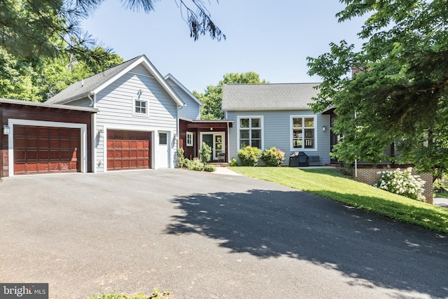 view of front of house with a front lawn and a garage