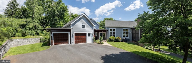 view of front of home featuring a garage and a front lawn