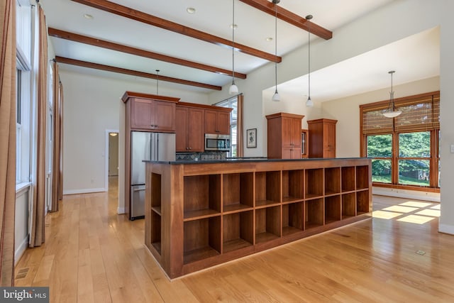 kitchen featuring light hardwood / wood-style flooring, appliances with stainless steel finishes, tasteful backsplash, decorative light fixtures, and beam ceiling