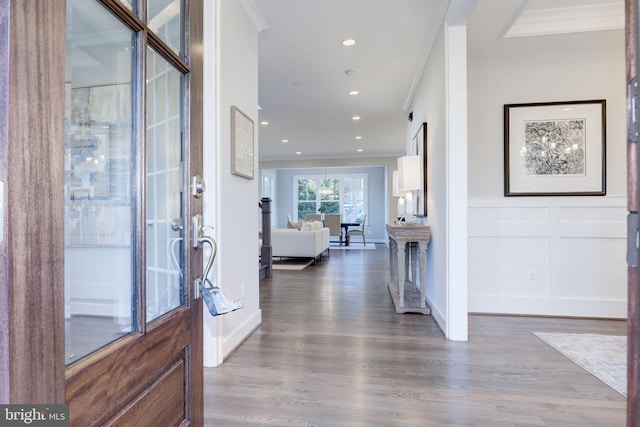 foyer entrance with hardwood / wood-style flooring and ornamental molding