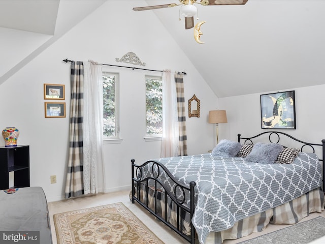 carpeted bedroom with ceiling fan and vaulted ceiling