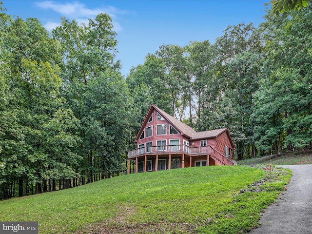 view of front of home featuring a deck and a front lawn