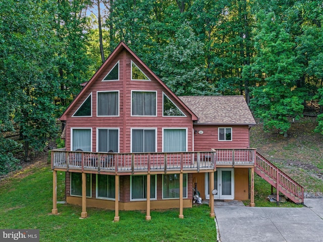 view of front facade with a patio, a front lawn, and a wooden deck