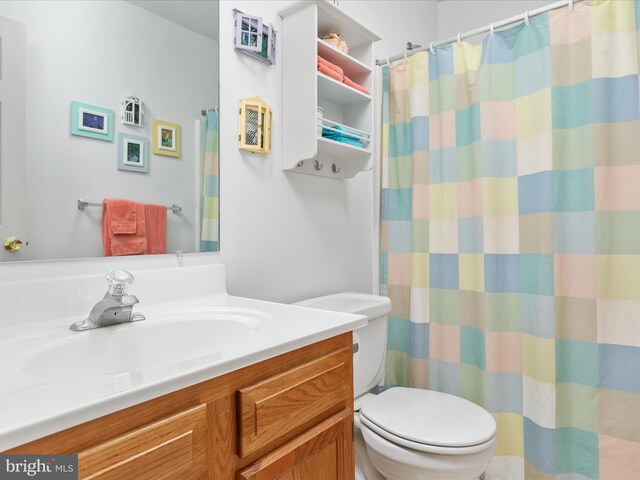 bathroom featuring vanity and toilet