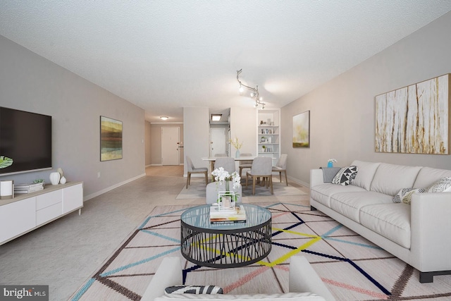 living room with built in features and a textured ceiling