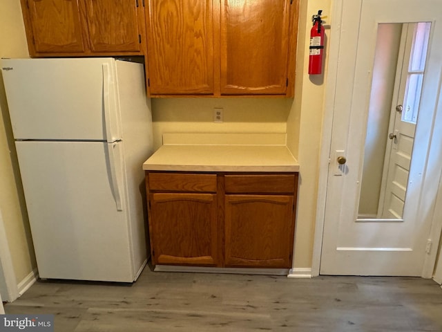 kitchen featuring light wood-type flooring and white fridge