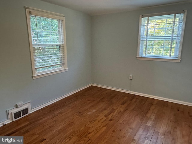 empty room with dark hardwood / wood-style floors