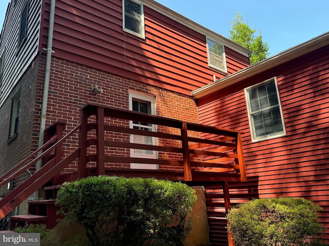 back of house featuring a wooden deck