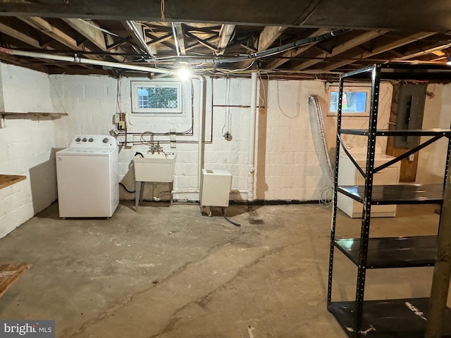 basement featuring washer / clothes dryer, sink, and electric panel