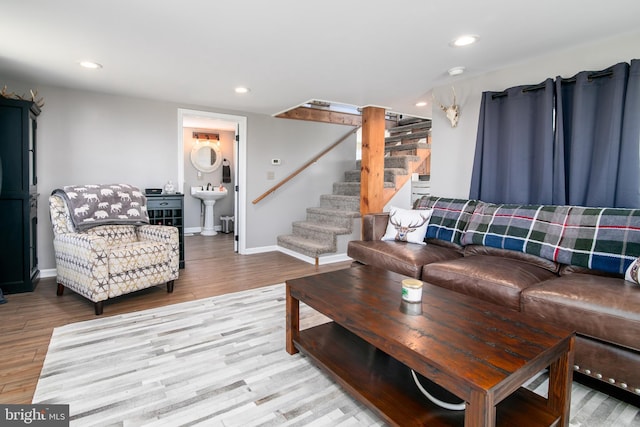 living room with sink and light hardwood / wood-style floors