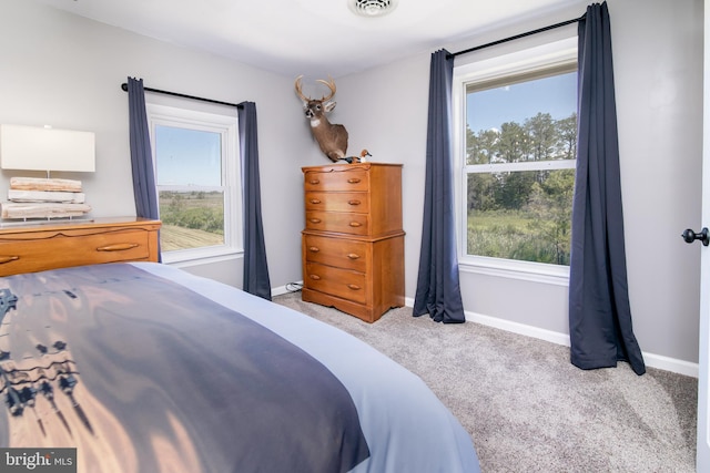 bedroom featuring light colored carpet