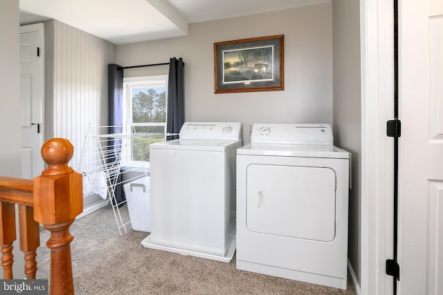 laundry room featuring washer and dryer and light colored carpet