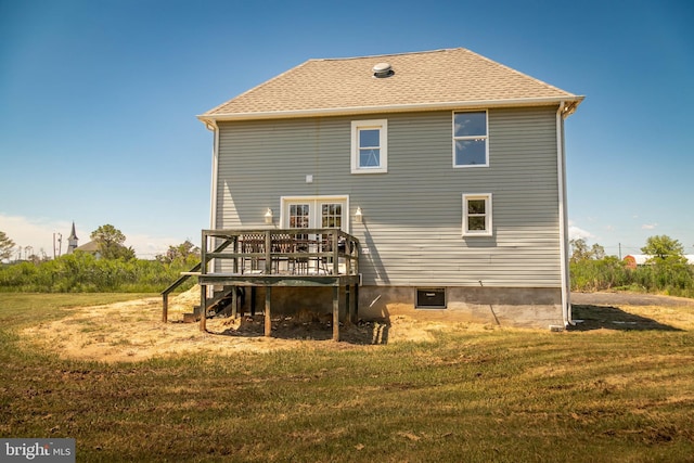 rear view of house with a wooden deck and a yard