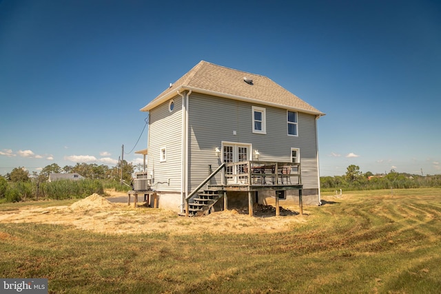 back of property with a wooden deck, a yard, and cooling unit