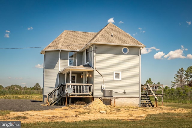 rear view of house featuring central air condition unit