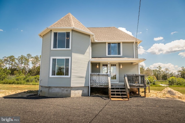 back of property with a porch