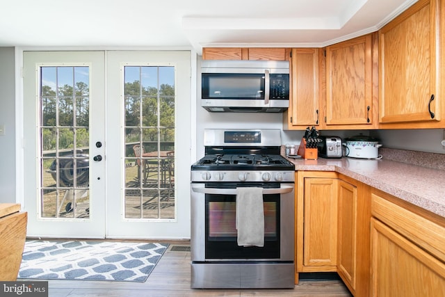 kitchen featuring dark hardwood / wood-style flooring, stainless steel appliances, and french doors