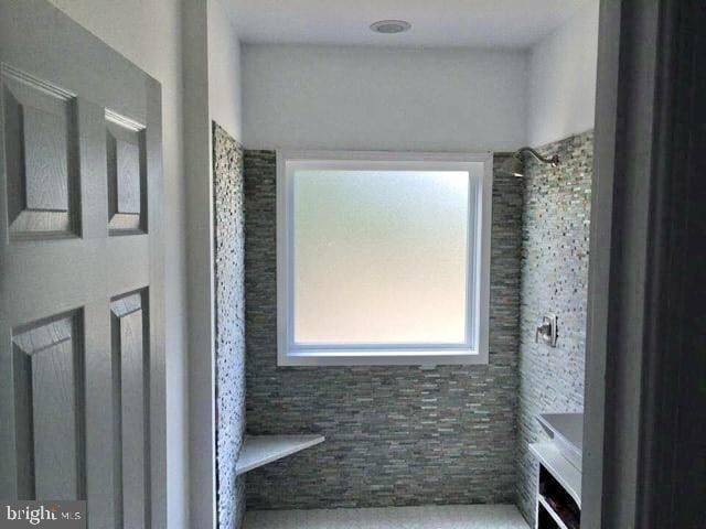 bathroom with a tile shower