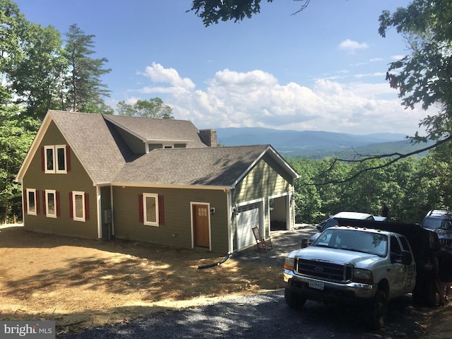 view of front facade with a mountain view and a garage