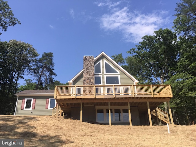 rear view of house with a wooden deck