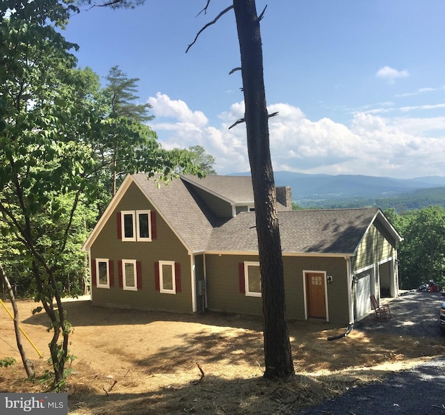 view of front of property featuring a mountain view and a garage