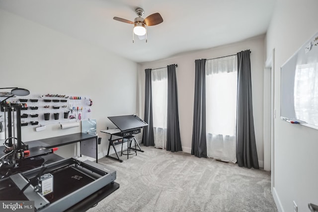 interior space with ceiling fan, light colored carpet, and a wealth of natural light