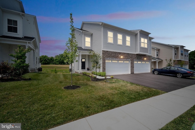 view of front of home featuring a yard and a garage