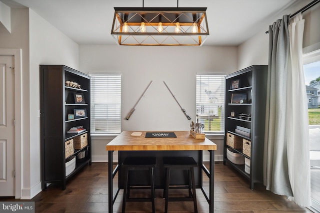 home office with dark wood-type flooring