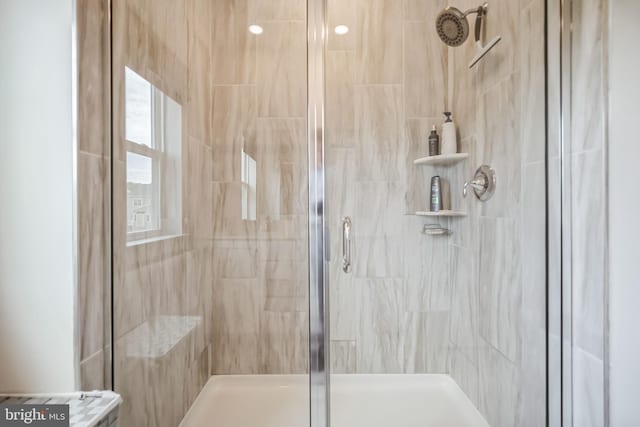 bathroom featuring a shower with door